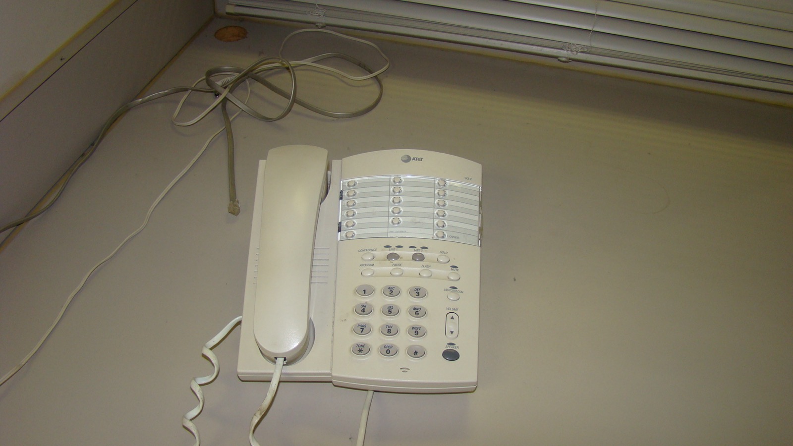 Beige AT&T two-line desk phone sitting on a countertop